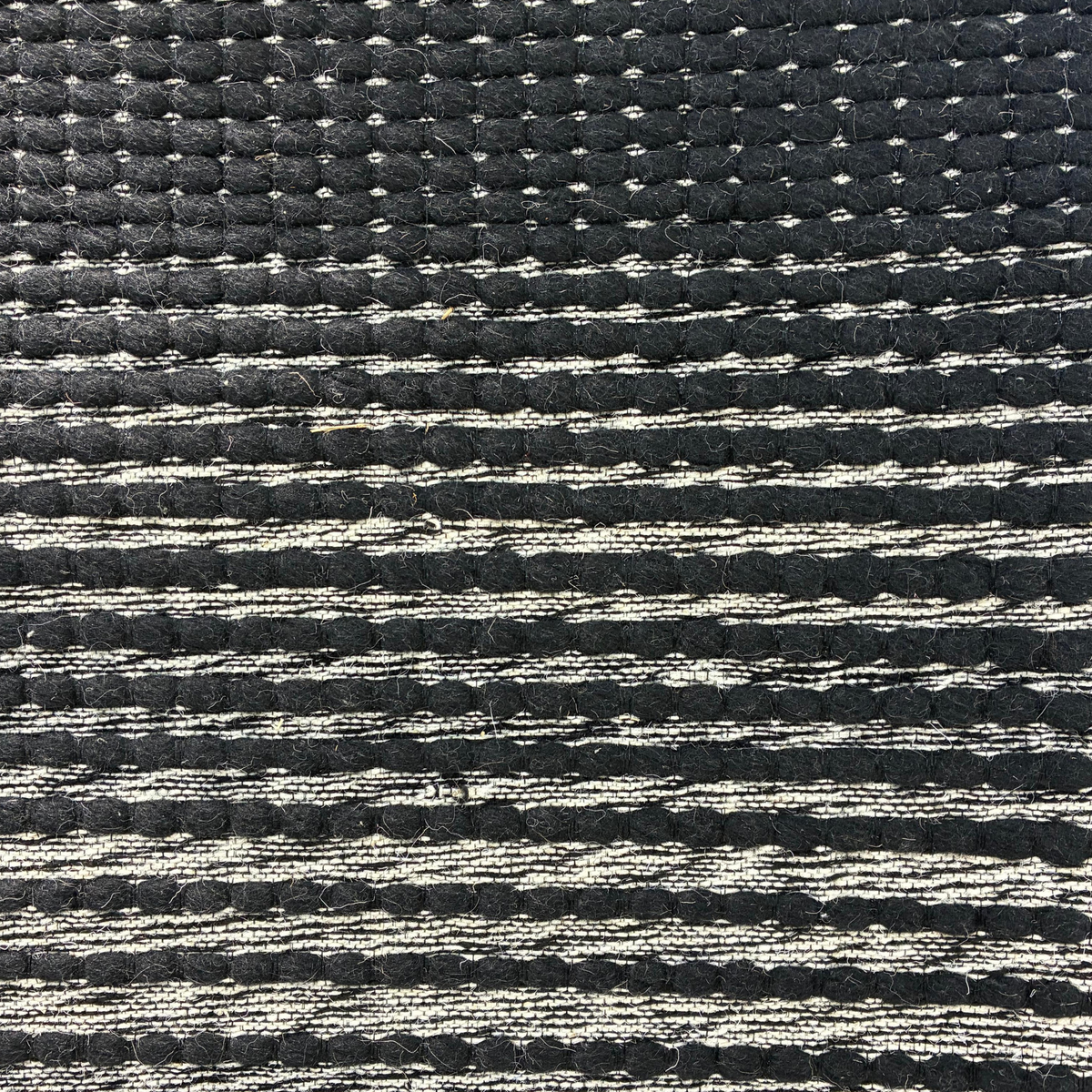 Dhara Rug in Bright White / Black — styled angle
